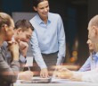 smiling female boss talking to business team