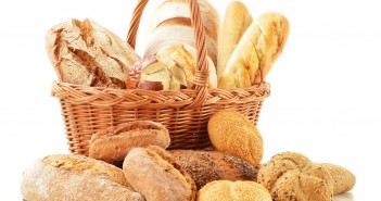 Bread and rolls in wicker basket isolated on white