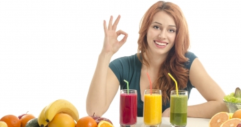 Happy woman having a table full of organic food,juices, smoothie
