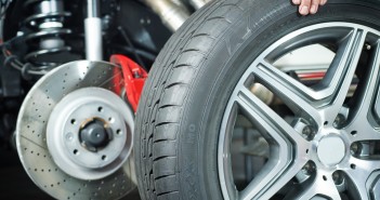 Car mechanic is changing a tyre in a garage